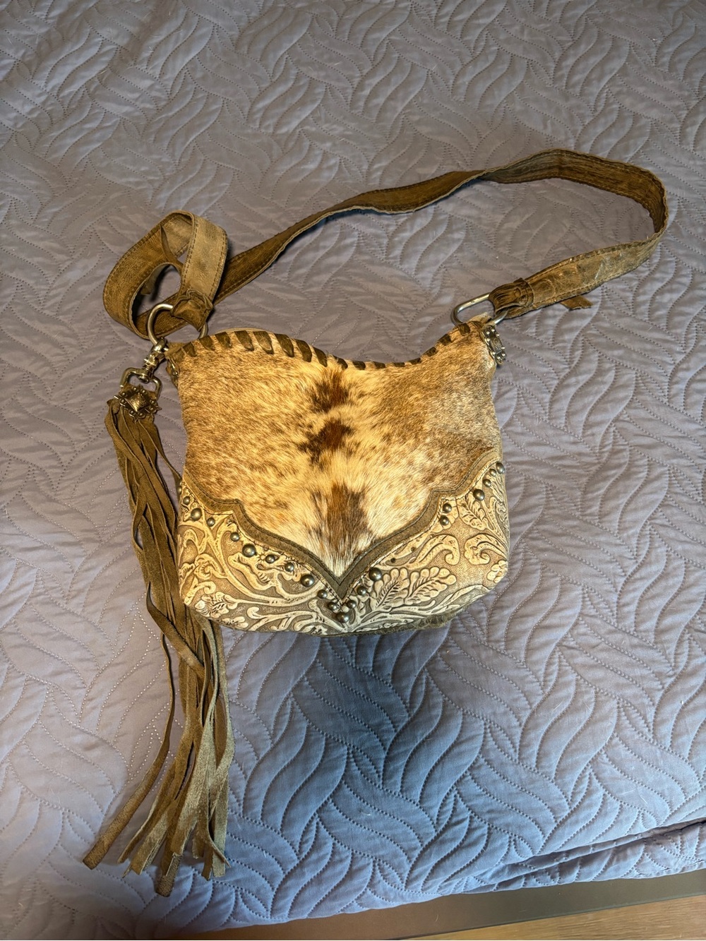 Leather handmade crossbody with hair on hide.